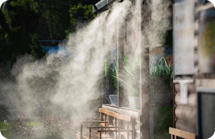 Commercial misting system spraying fine mist over an outdoor dining area - creative uses for misting kits beyond cooling